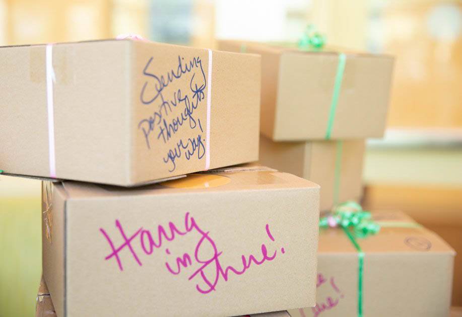 Kingsley Ikeata, a student who works for Housing, loads care packages on a cart to be delivered to students in isolation or quarantine.